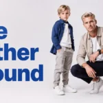 Father crouching beside his young son on a white background next to the words “The Father Wound.”